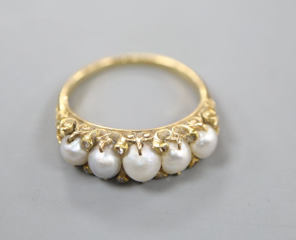 A Victorian yellow metal, graduated split pearl and diamond chip set half hoop ring, size R, gross 5.2 grams.